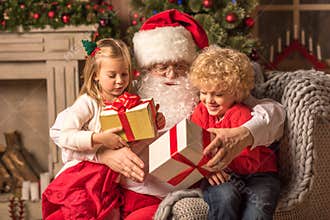 Santa Claus with children holding gift boxes