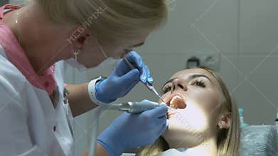 Medical dentist procedure of teeth polishing with cleaning from dental deposit and odontolith