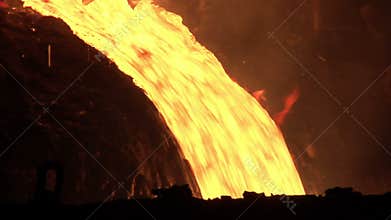 Hot metal pout out from blast furnace. Molten metal pouring from furnace