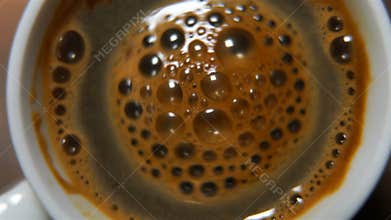 White cup with a black coffee.