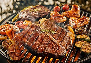 T-bone steak grilling over a portable barbecue