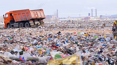 Trucks at a huge landfill.
