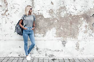Model posing in plain tshirt against street wall
