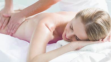 Professional beautician massaging body of girl