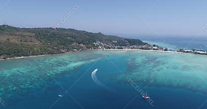 Aerial drone video of iconic tropical beach and resorts of Phi Phi island