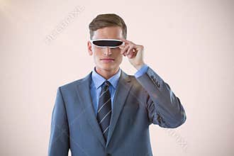 Composite image of handsome businessman virtual reality glasses