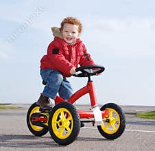Happy boy on trike, bike