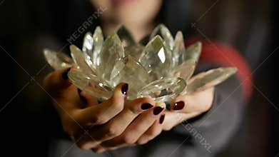 Young woman gives a crystal lotus from her heart