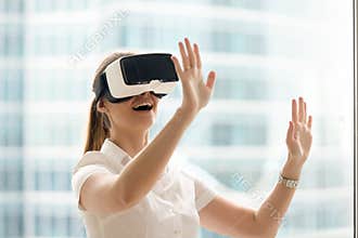 Curious amazed woman trying augmented reality glasses, virtual l