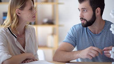 Millennial scientists discussing DNA model together