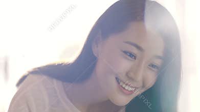 Young Asian mother smiling and waking up her baby slow motion