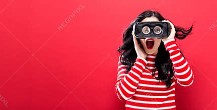 Young woman using virtual reality headset
