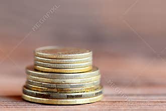 Tower of coins on a wood background. Financial concept. Money. Closeup