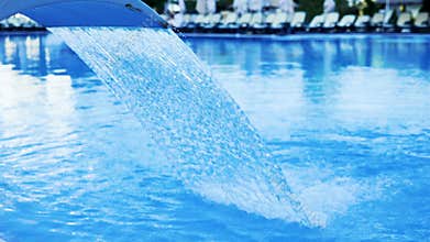 Slow motion of Water fountain treatment in the pool of luxury hotel