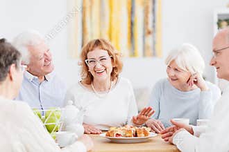 Happy seniors chatting at cafe
