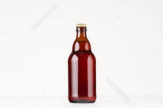 Brown steinie belgian beer bottle 330ml mock up. Template for advertising, design, branding identity on white wood table.