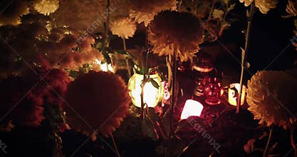 Candles burn in the cemetery