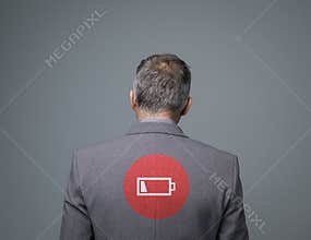 Exhausted businessman with low charge icon