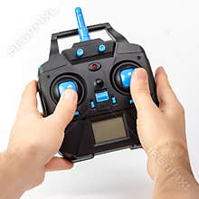 Hands holding drone remote control