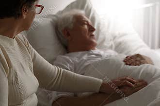 Senior man in hospital bed