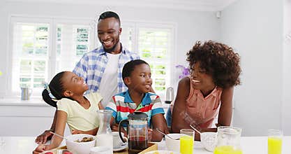 Happy family at breakfast table