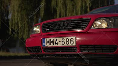 A car of a red color of the brand Audi