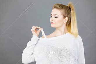 Woman holding her bra strap