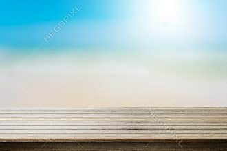 Wood table top on blurred beach background, summer concept.