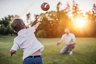 Dad with son playing baseball