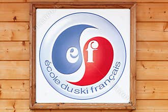 French ski school logo on a wall