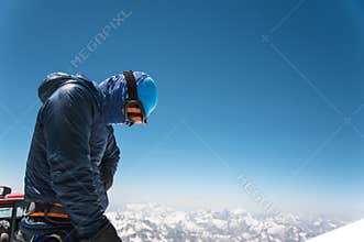 Professional guide - climber on the snow-covered summit of Elbrus sleeping volcano
