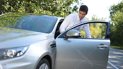 Stylish business executive getting into luxury car
