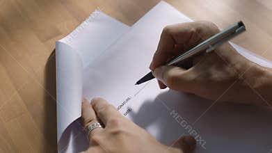 Hands of businessman sign document