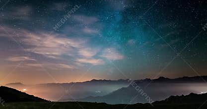 Time Lapse of the Milky way and the starry sky moving over the Italian Alps with fog and moisture resulting in a dreamlike effect.