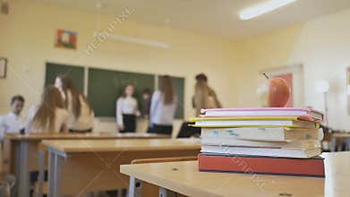 School break in the classroom. Books with apple are on the table. School theme.