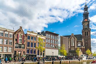 Tourists waiting in line to get in to the Anne Frank house in Amsterdam next to the Westertoren
