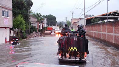 Policemen patrol the streets in vans to help the population due the flood.