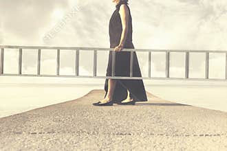 Woman carries a long ladder to climb into the sky