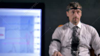 Young man connected to the lie detector circuit.