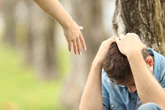 Sad teen and a hand offering help