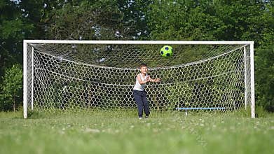 Father and son playing football on the football at the day time