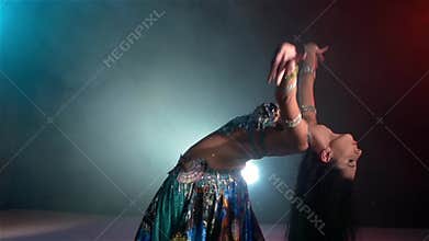 Beautiful young belly dancer starts dancing, slow