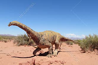 Dinosaur model on the sand