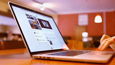 Girl in cafe and reads the news Facebook