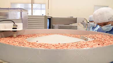 Pills packaging after sorting on aseptic conveyor at pharmaceutical factory