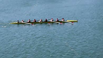 Womens Crew Team Rowing On Lake Panned Shot