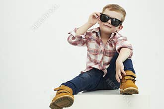 Funny child. fashionable little boy in sunglasses. stylish kid in yellow shoes
