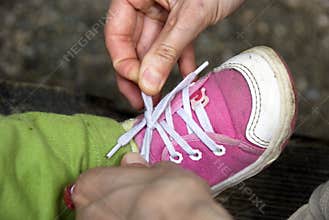 Tying baby shoes