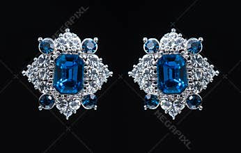 Earring with colorful blue gems on black