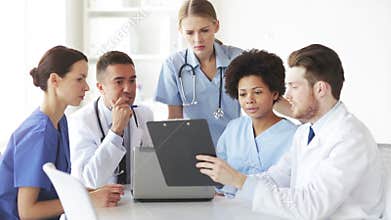 Group of doctors with clipboard talking at clinic